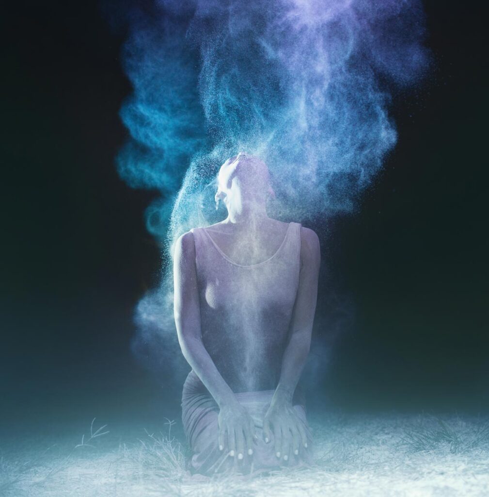 woman kneeling with smoke around her